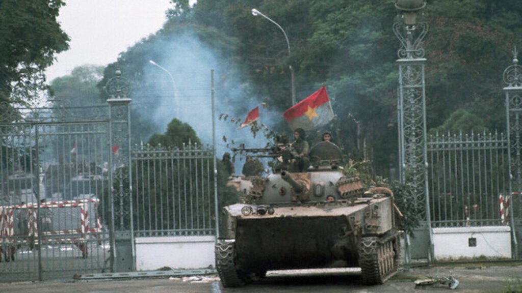 30 Apr 1975, Saigon, South Vietnam --- A North Vietnamese tank rolls into a compound during the fall of Saigon, 1975. --- Image by © Francoise de Mulder/CORBIS